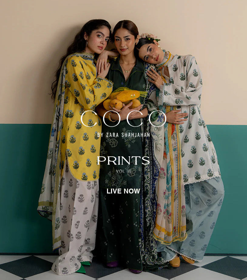 Three women in patterned outfits standing against a wall with 'COCO by Zara Shrihajhan' branding.